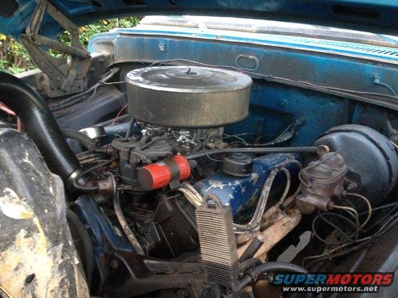 Blue 1971 Ford F-250 engine bay with a large air cleaner and carburetor