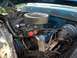 1971 Ford F-250 - The engine bay of a blue 1971 Ford F-250 shows a V8 engine with a prominent air filter and carburetor assembly.