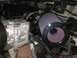 1988 Ford Bronco - Close-up view of an engine bay, highlighting an aftermarket air filter and AC compressor.
