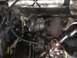 1988 Ford Bronco - Close-up view of engine components, including a turbocharger and various hoses and pipes.