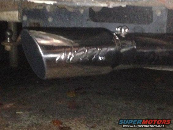 Chrome exhaust tip with engraved lettering, clamped to exhaust pipe
