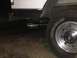 1988 Ford Bronco - Close-up of a white Ford Bronco's rear wheel and exhaust system.