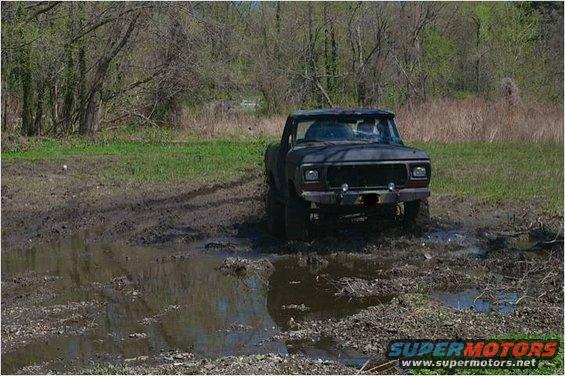 Ford F-Series truck stuck in mud, front view. Looks like a 1979 model