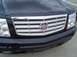 2004 Cadillac CTS - Close-up of a black Cadillac's front grille, the distinctive Cadillac emblem and chrome accents.