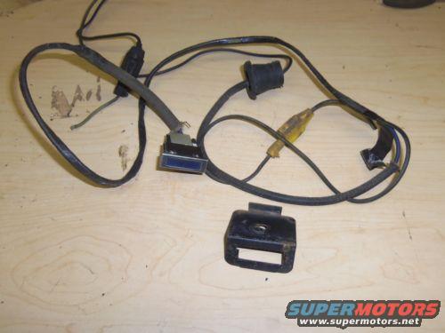 wiring harness with a blue connector and a metal bracket on a wooden surface