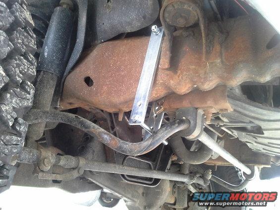 Its best to attach the bracket up front and slide it back because of the inner fender being in front of the top bolt