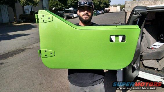 Man holding bright green Jeep door, vehicle interior visible behind him