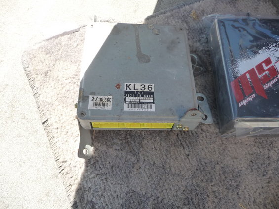 Gray engine control unit with yellow connector and KL36 label