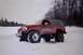 1995 Ford Bronco - This lifted 1995 Ford Bronco navigates a snowy landscape with its large off-road tires.