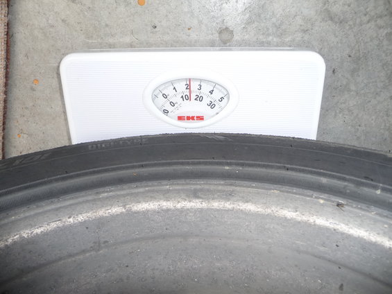 Tire resting on a bathroom scale