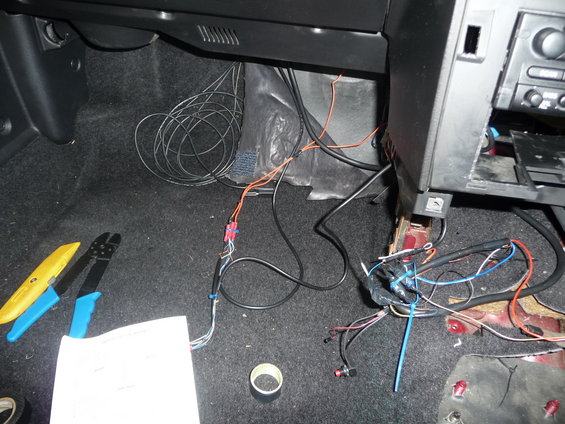Car interior with wiring and tools on the floor