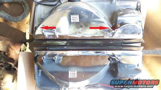 Two chrome headlights with red arrows pointing to mounting points