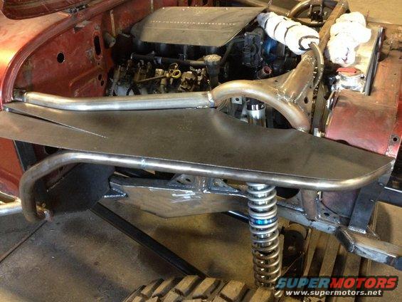 custom off-road vehicle chassis with engine and suspension components visible