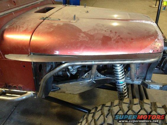 Red Jeep CJ7 body and suspension with custom roll cage and large tires