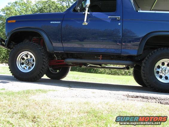 Blue 1982 Ford Bronco side view with lifted suspension and aftermarket wheels