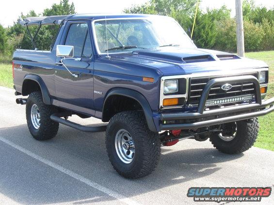 Blue Ford Bronco with aftermarket hood scoop, bull bar, and light bar