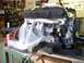 1974 Dodge Challenger - Engine assembly, partially covered, sits on a workbench in a garage setting.