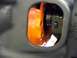 1974 Dodge Challenger - A close-up view shows an orange engine part through an opening in a gray housing.