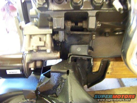Close-up of an engine mount bracket with some text on a filter