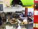 1974 Dodge Challenger - A mechanic works on parts in a cluttered garage, with a car body suspended on a lift.