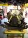 1974 Dodge Challenger - Engine assembly on a stand, ready for installation under a vehicle lifted on a car lift.