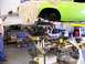 1974 Dodge Challenger - Engine installation in progress on a 1974 Dodge Challenger, with the car body elevated on a lift.