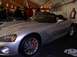 1990 Ford Bronco - A silver convertible sports car, identified by its Viper badging, is displayed indoors with people in the background.