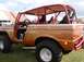1990 Ford Bronco - This customized Ford Bronco features a prominent red roll cage and flame graphics on its body.