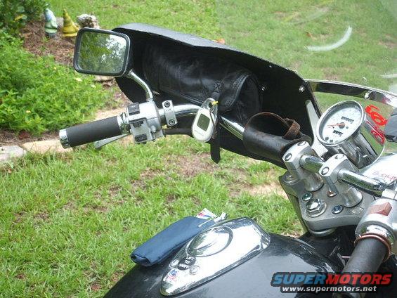 Motorcycle handlebars with speedometer and leather pouch
