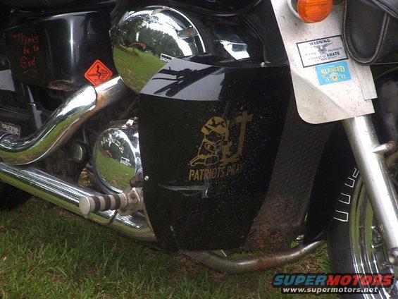 Black motorcycle side panel with 'PATRIOTS PRAY' decal and a sticker that says 'BLESSED'