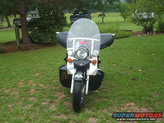 Motorcycle with large windshield and saddlebags, front view