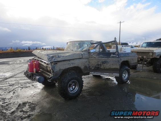 Muddy pickup truck with gas cans, 3q-front view
