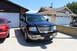 2003 Ford Expedition - A black 2003 Ford Expedition is parked in the driveway of a suburban home, with a red sedan to its left.