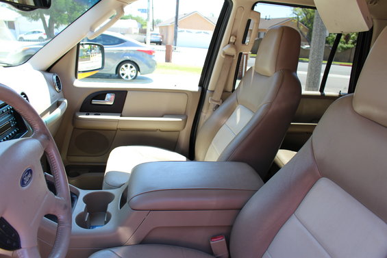 Interior shot of a 2003 Ford Expedition showing the front seats, center console, and dashboard