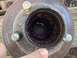 1979 Ford Bronco - Close-up of a rusty wheel hub, showing the splined interior filled with purple grease.