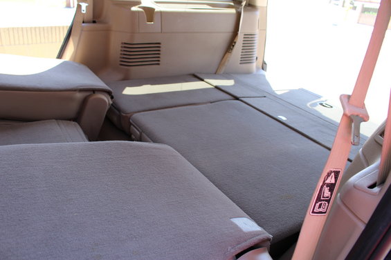 2003 Ford Expedition interior showing folded rear seats and seatbelts