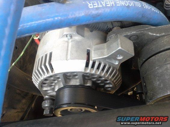 1991 Ford F-250 alternator with a blue silicone heater hose above it