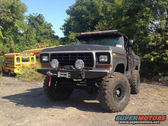 Modified 1979 Ford Bronco with large off-road tires and winch