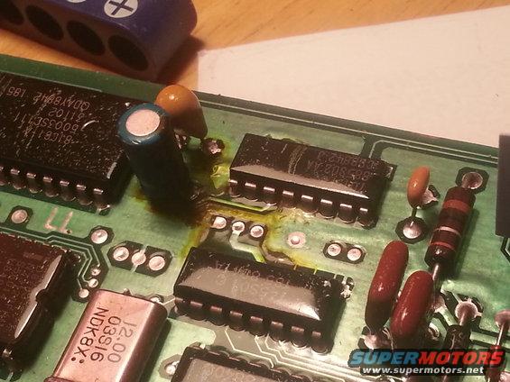 Circuit board with damaged yellowing, integrated circuits, capacitors, and resistors