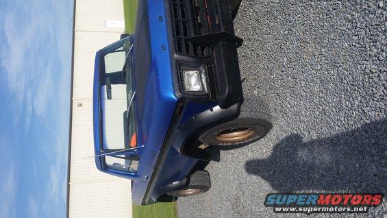 Blue 1978 Ford Bronco with black grille and fender flares, viewed from a 3/4 front angle