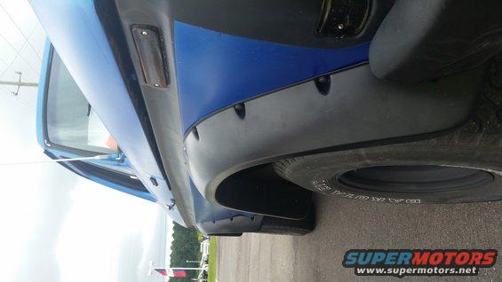 Blue SUV fender and tire with black fender flares