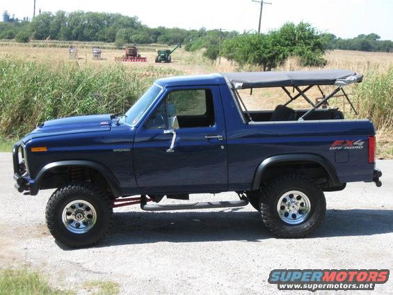 Blue 1982 Ford Bronco side view with soft top and FX4 Off Road decal