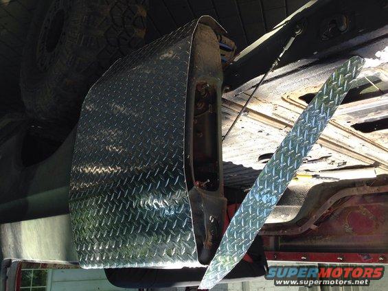 diamond plate fender flare installed on a vehicle, showing the underside and tire