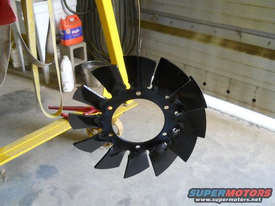 Black fan blade hanging from yellow equipment