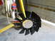 1992 Ford Bronco - A black fan blade is suspended from yellow equipment in a workshop setting.