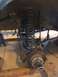 1996 Ford Bronco - Close-up of a vehicle's front suspension and brake components, likely during maintenance.