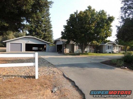 House with attached garage and detached garage. Driveway in front