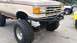 1988 Ford Bronco - This lifted Ford Bronco features a custom front bumper and large off-road tires.