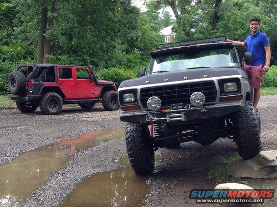 Black 1979 Ford Bronco with winch and light bar, parked on rocks
