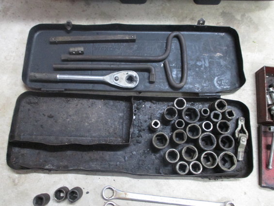 Tool kit with ratchet, sockets, and extensions in a metal case